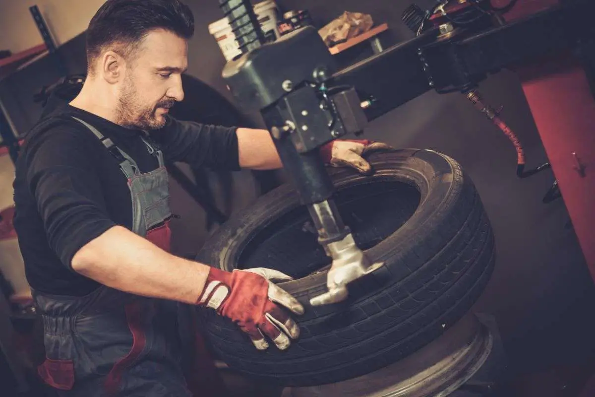 professional mechanic working on tire
