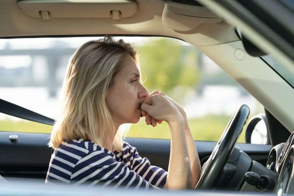 woman driving feeling anxious